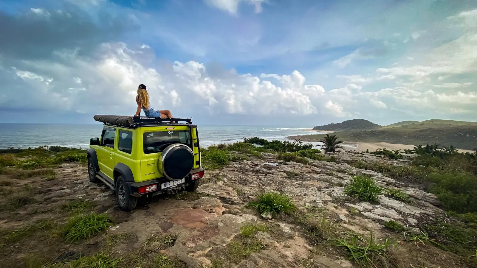 A Woman Sitting on Top of a Vehicle