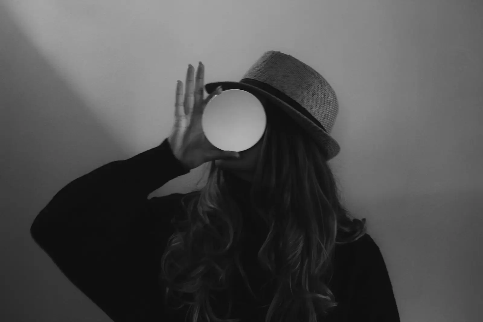 woman in black long sleeve shirt wearing brown hat