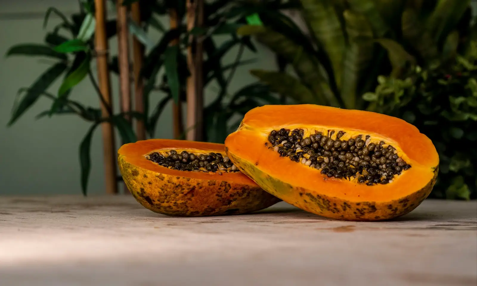 sliced papaya fruits on brown surface