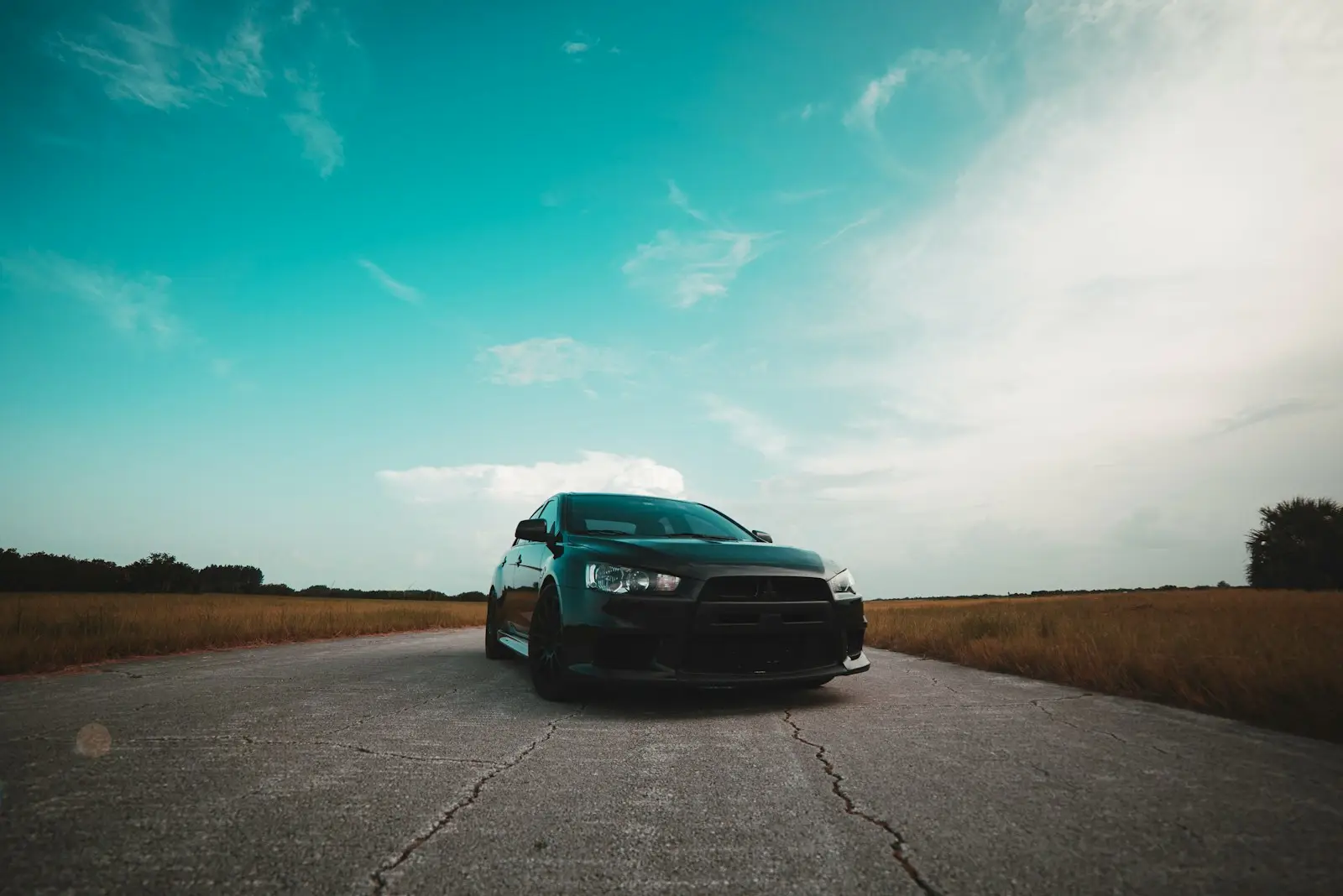 black vehicle on gray concrete road