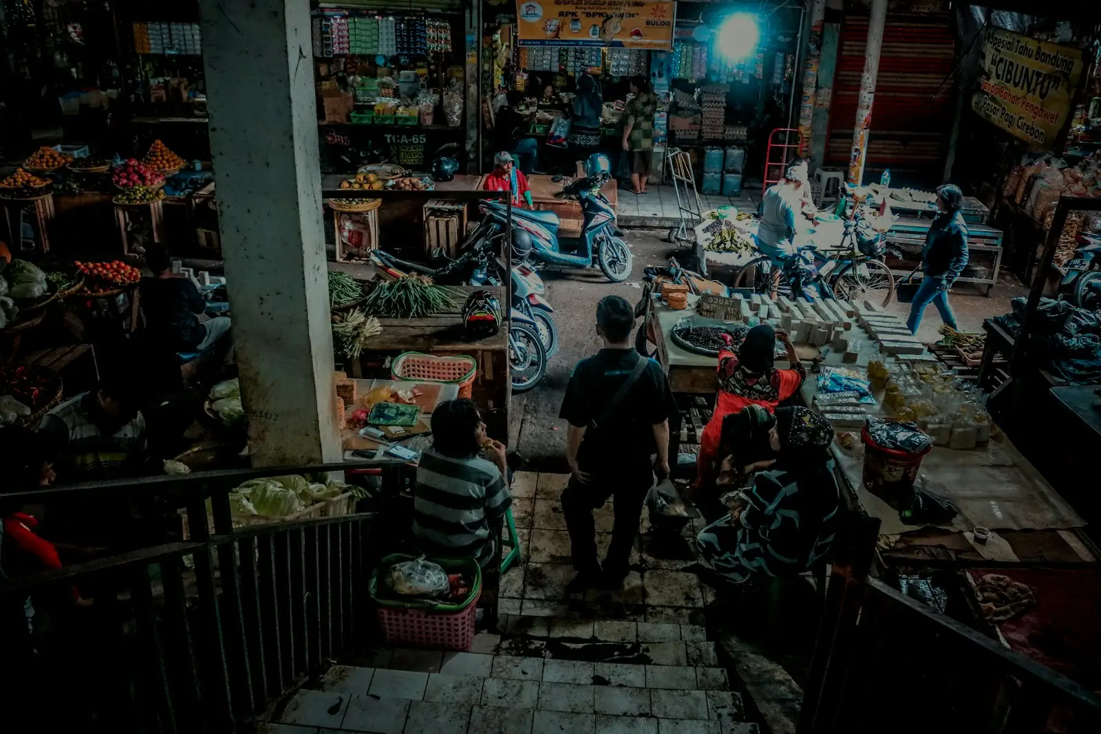 a group of people standing around a market