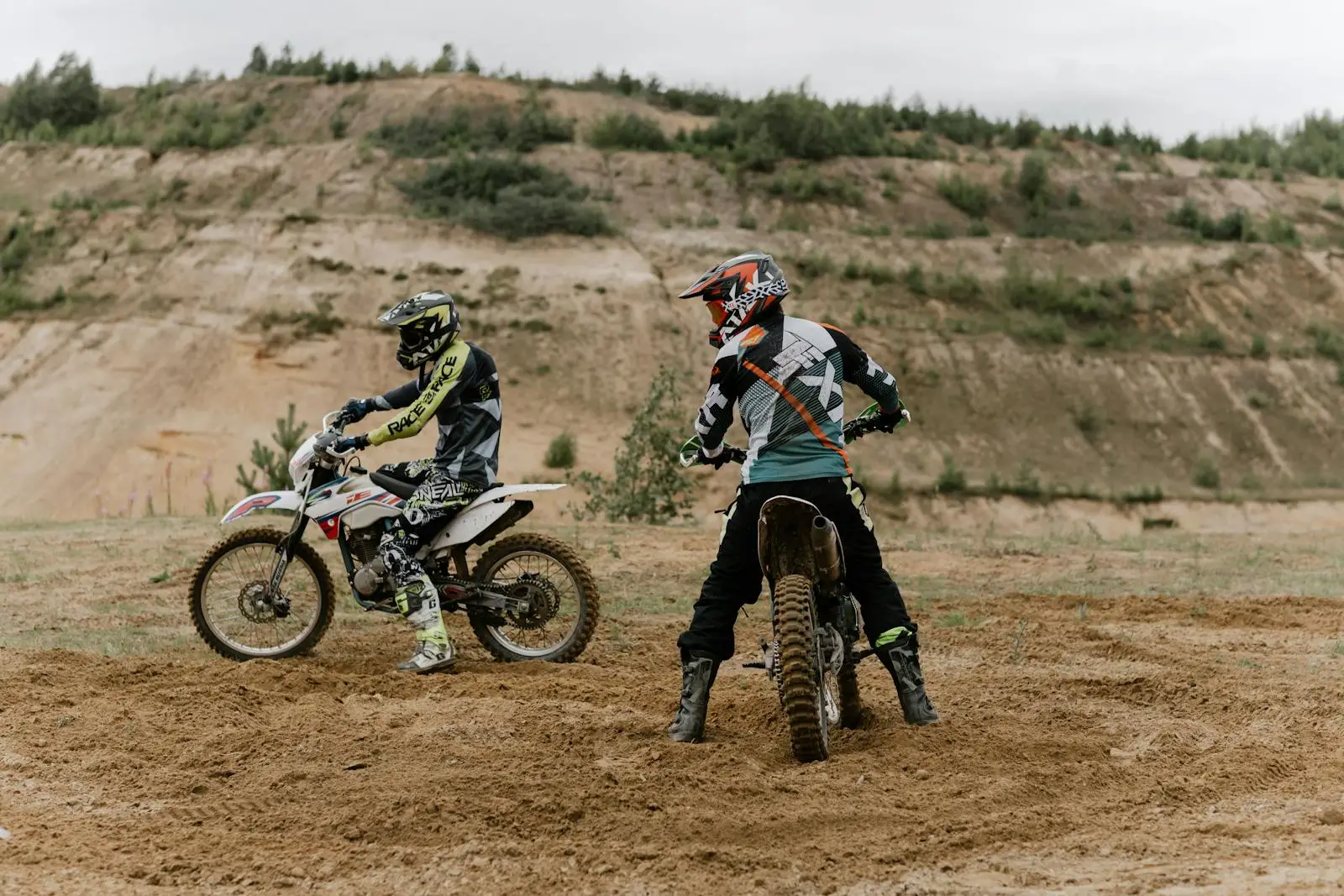 Riders in Full Gear riding a Dirt Bike